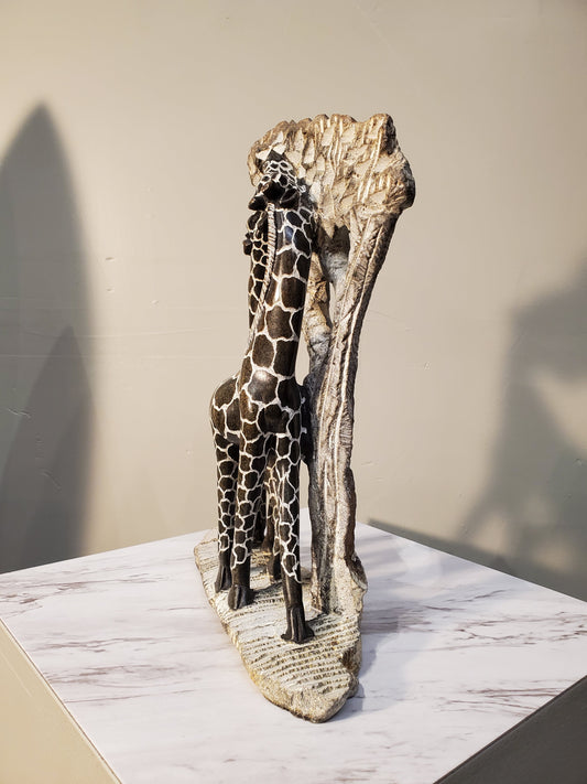 Two giraffes eating from a tree. The giraffes have a beautiful pattern of brown circles outlined in white. Colors include: Brown, White, Tan.