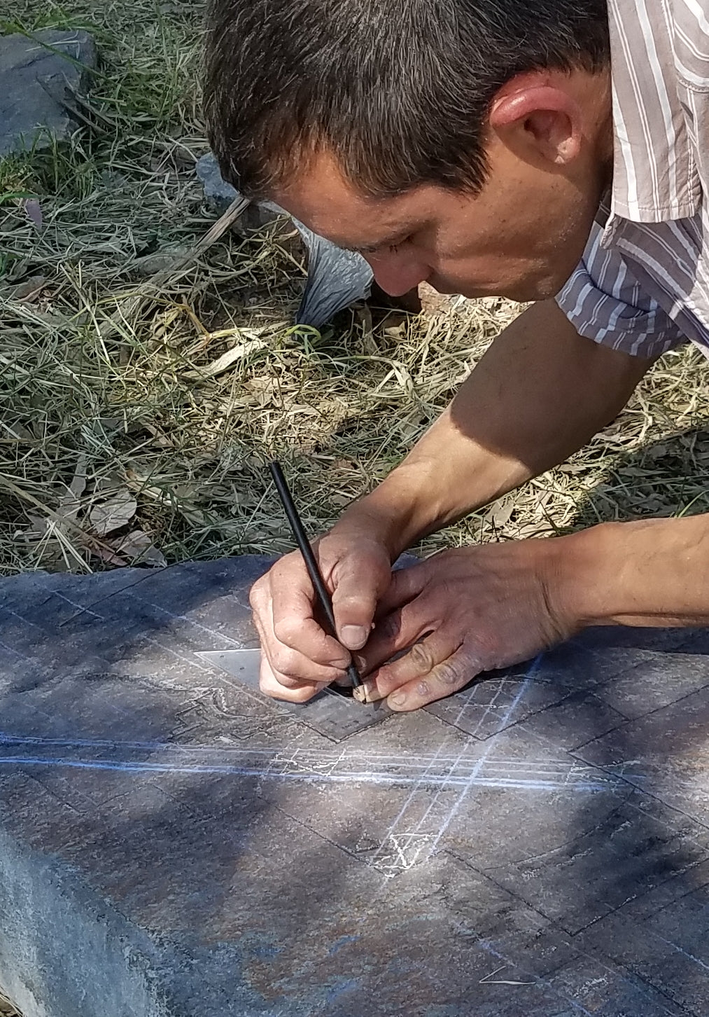 Artist Itai Chazan at work outlining his art piece.