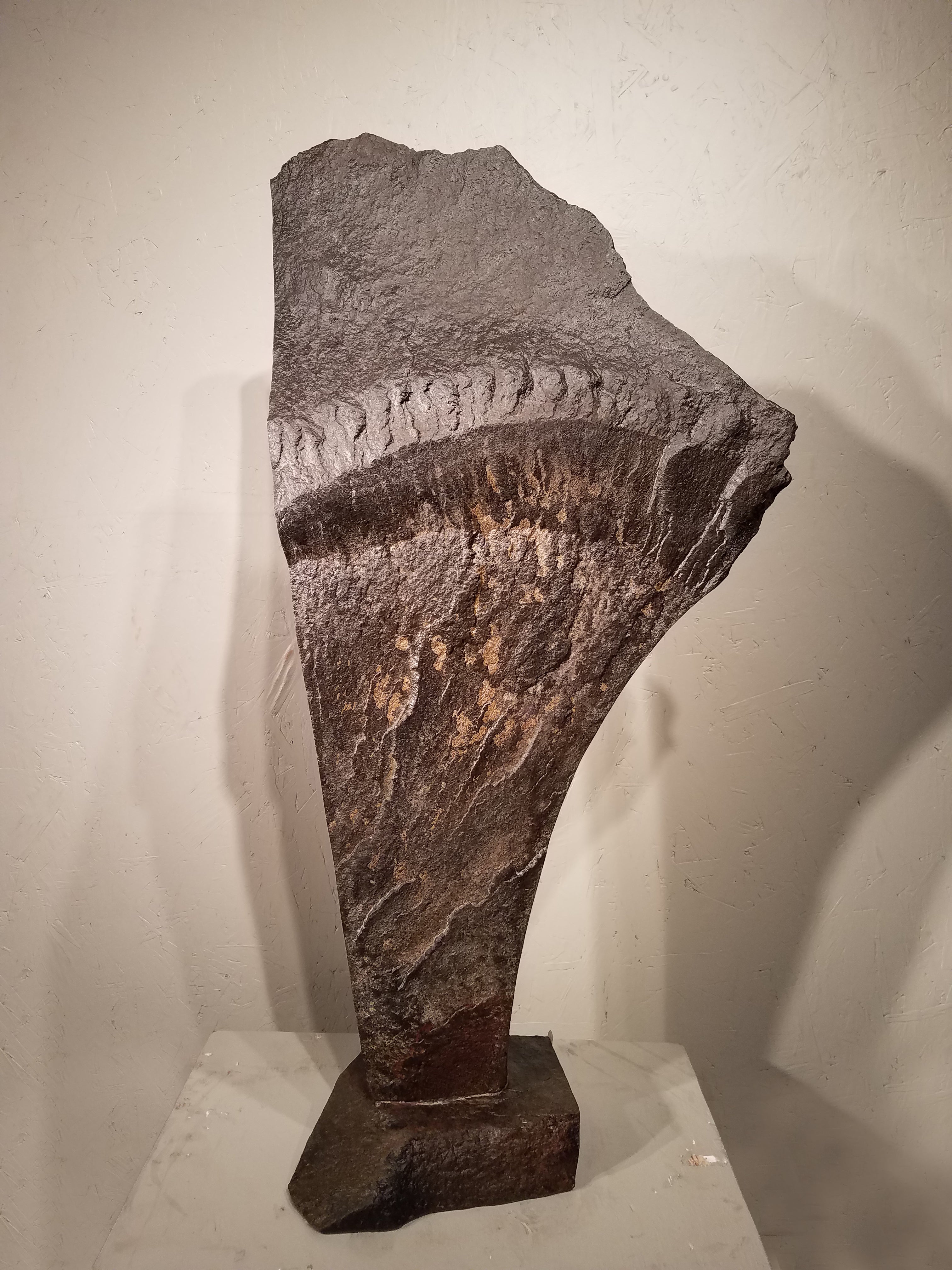 Dark brown curved shaped spring stone smoothed on one side with added dremmeled white lines. The carved out spring stone is set upon a black stone base that allows it to be propped upright. Colors Included: Black, White, Dark Brown.