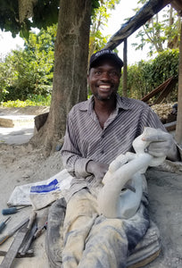 Artist Herbert Mwandiringa working on sculpture