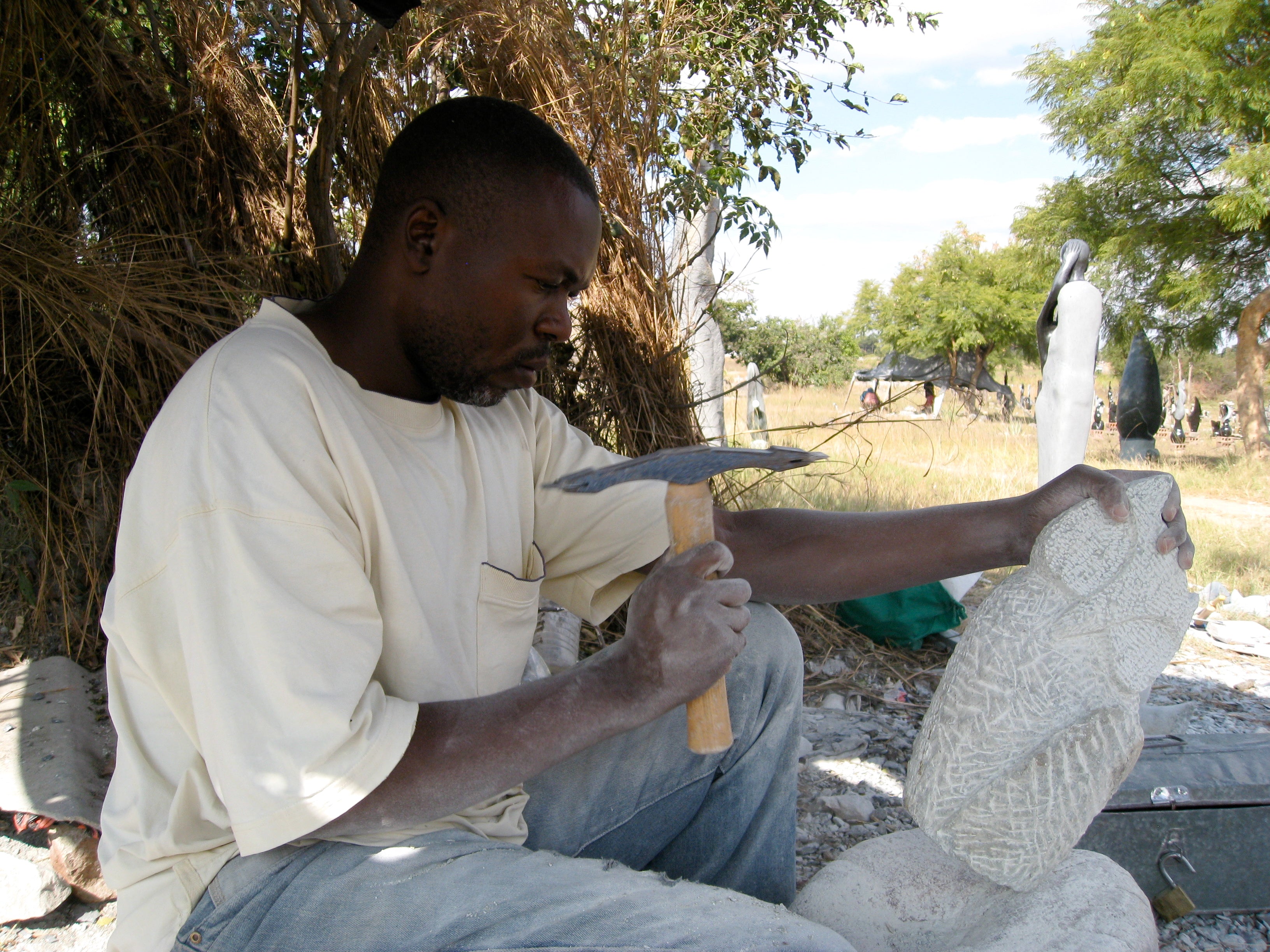 Artist Peter Chidzonga at work creating a beautiful stone sculpture. 